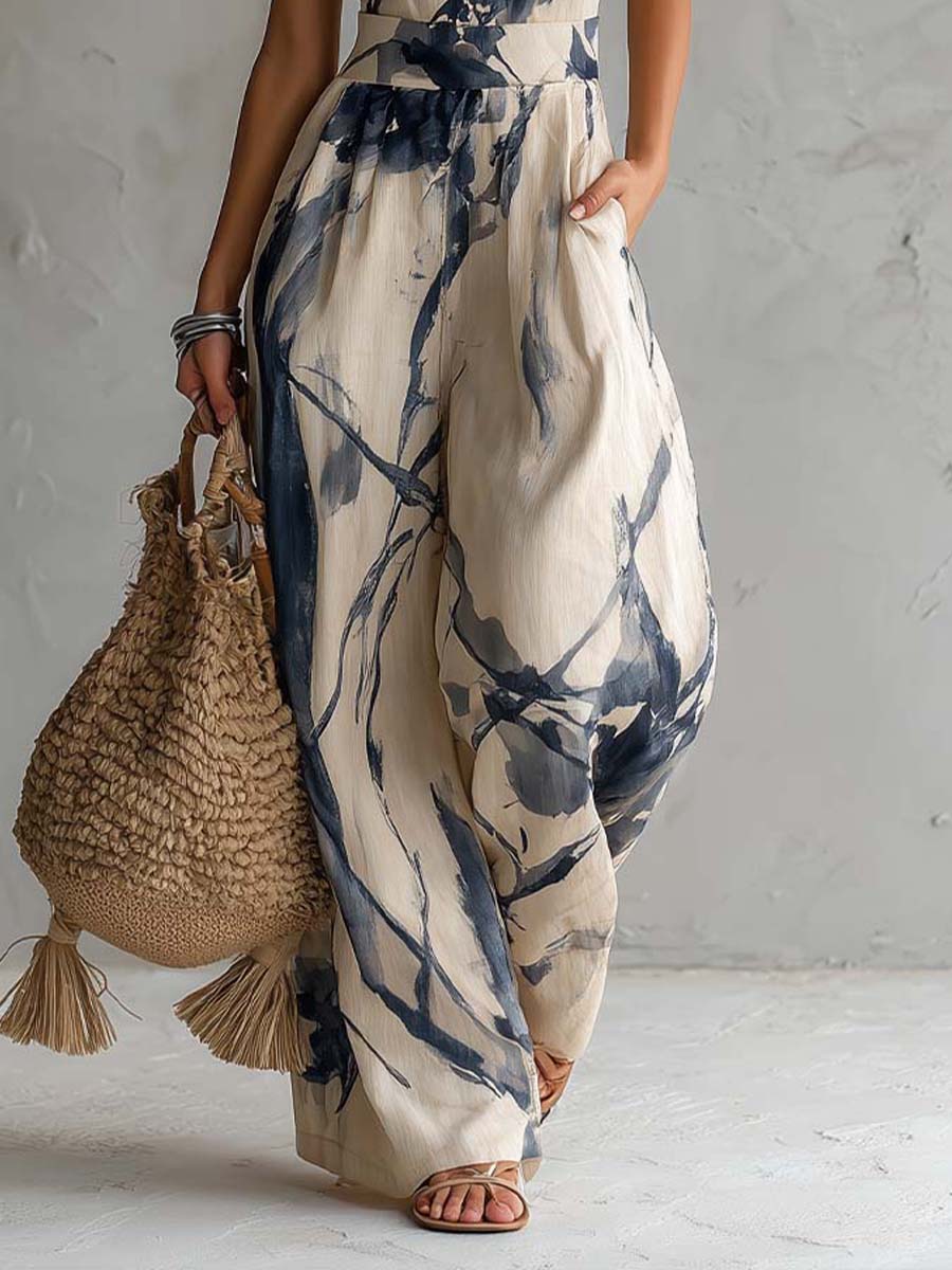 Mono con cuello halter, estampado efecto tinta, pierna ancha y bolsillos